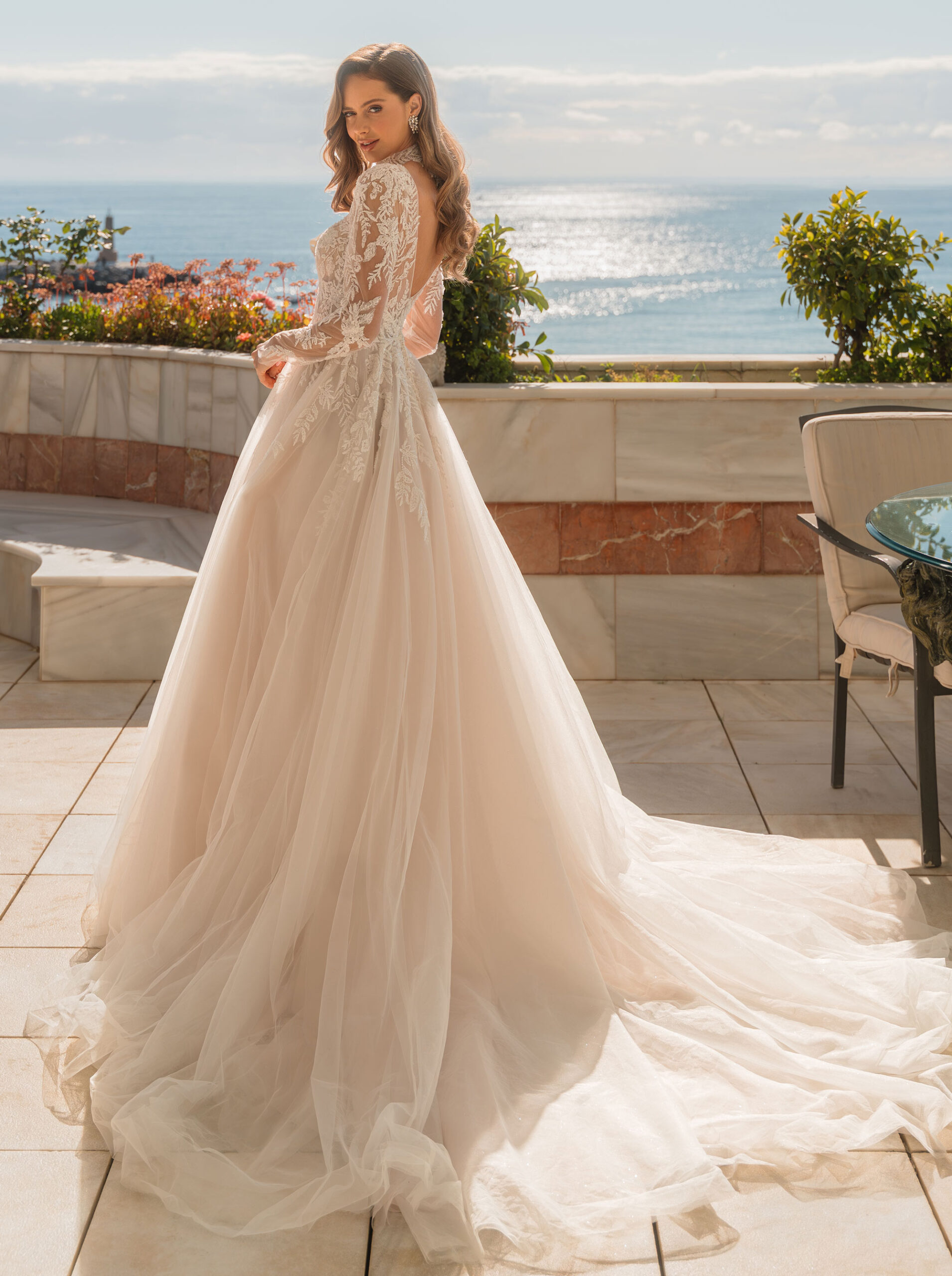 Romantisk brudklänning med broderad spets, skimrande tyllkjol och långa spetsärmar från Jolie Bridal i Malmö.